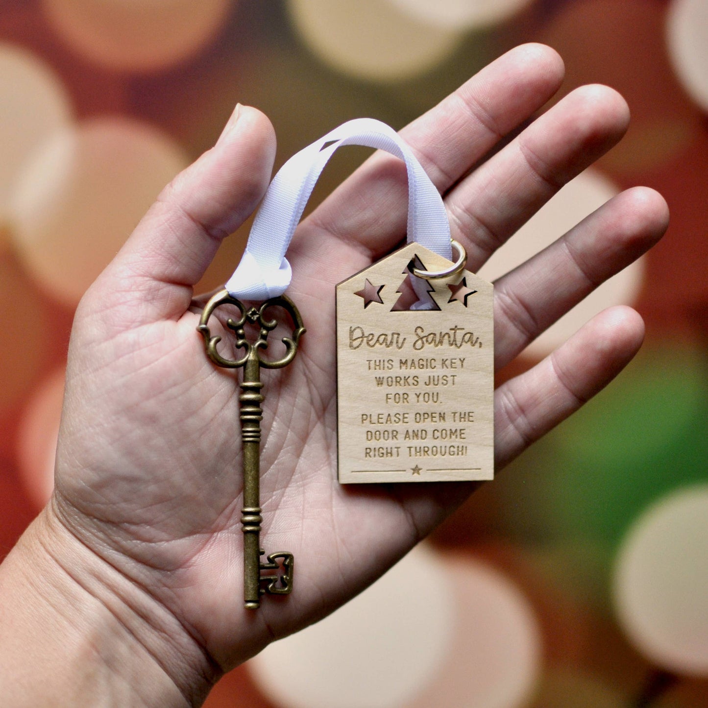 beautiful bronze vintage skeleton key tied with a white ribbon to a laser engraved christmas wooden letter to santa that says dear santa this magic key works just for you. please open the door and come right through